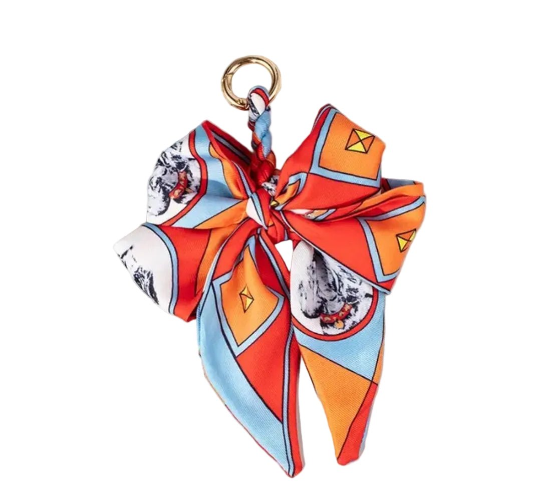 Colorful scarf keychain with geometric pattern on a white surface