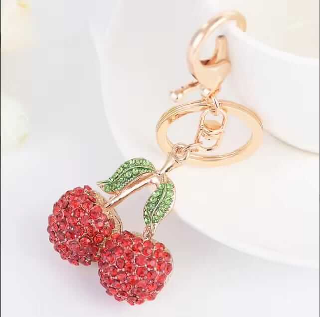 Two rhinestone cherries on a gold-tone stem