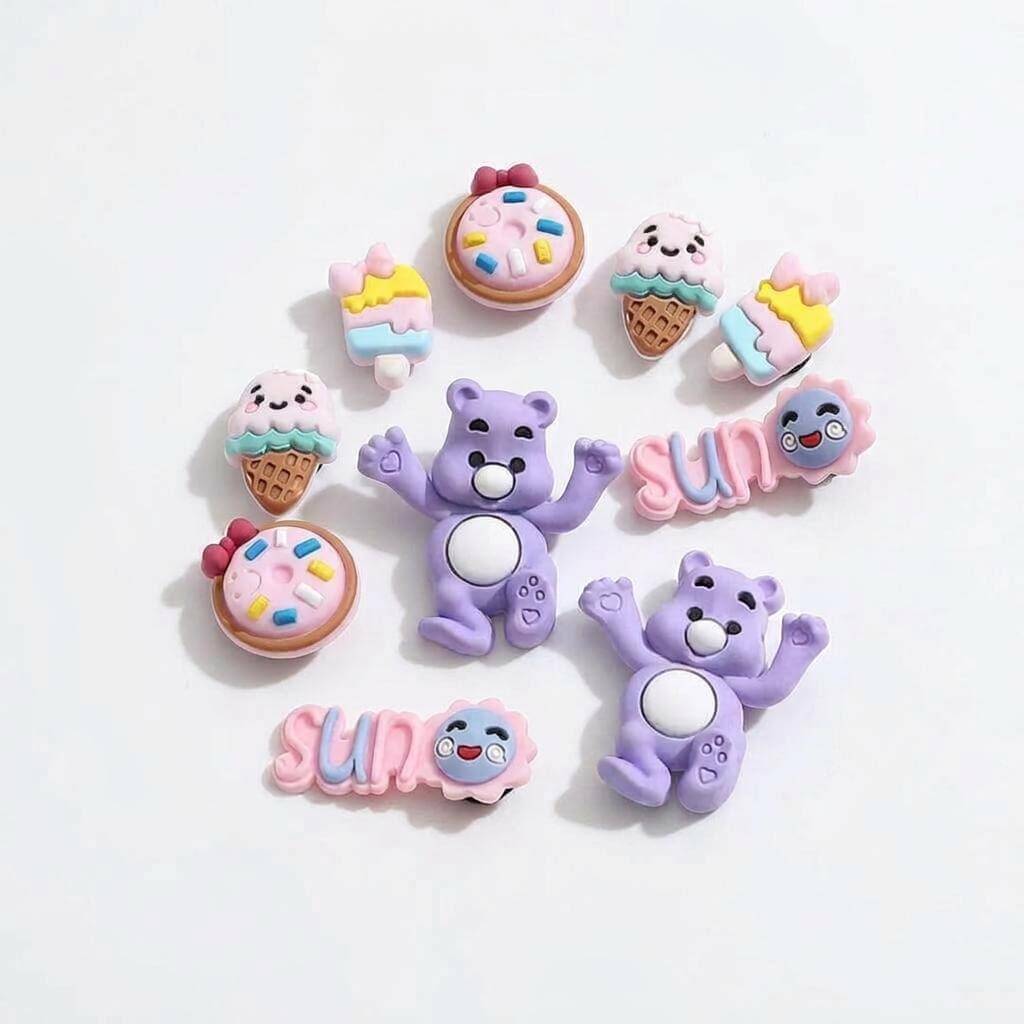 Set of colorful cartoon character charms on a light background