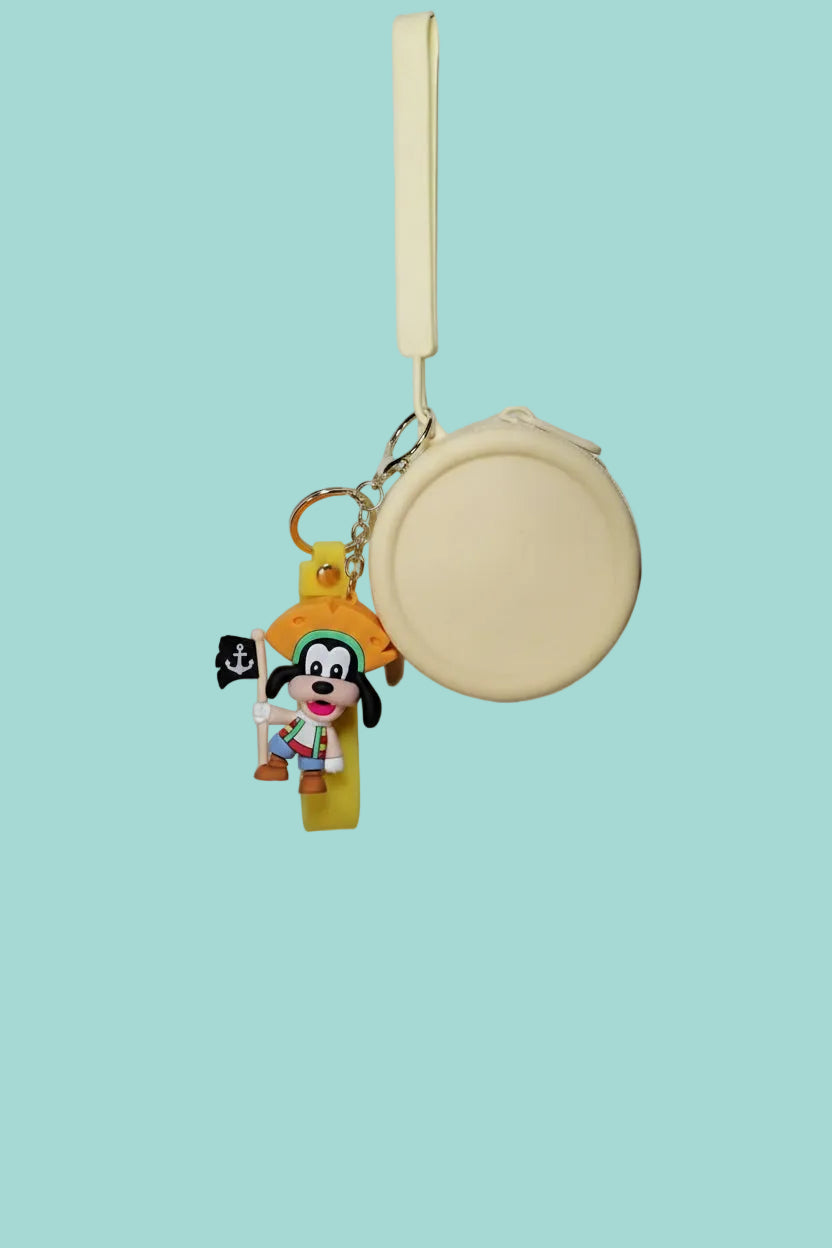 Small round pouch with a keychain featuring a cartoon character on a textured white background