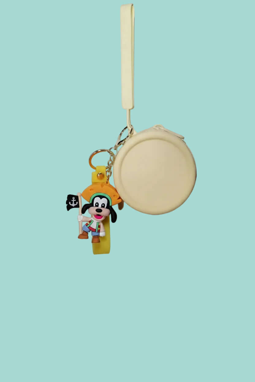 Small round pouch with a keychain featuring a cartoon character on a textured white background