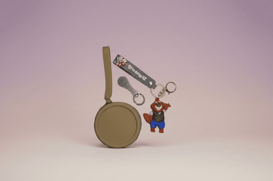 Round keychain with a cartoon character on a light purple background