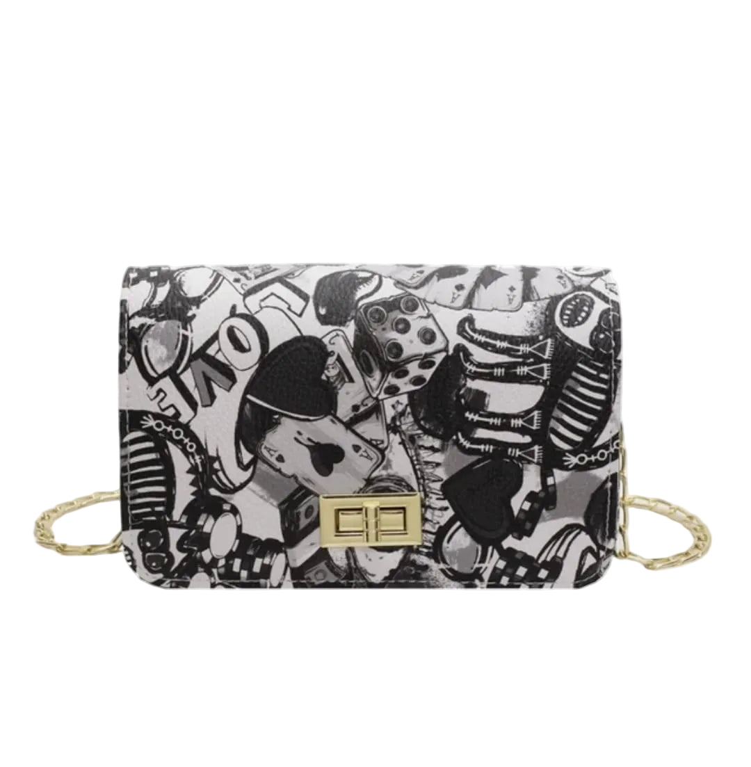 Black and white patterned handbag with gold accents on a white background