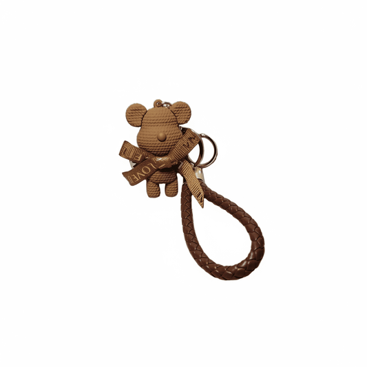 Brown teddy bear keychain with a strap on a white background