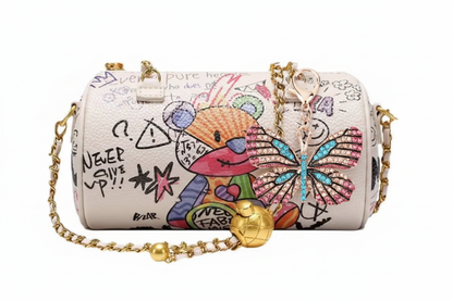 Butterfly keychain dangling from side of graffiti cylinder bag
