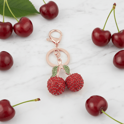 Two rhinestone cherries on a gold-tone stem