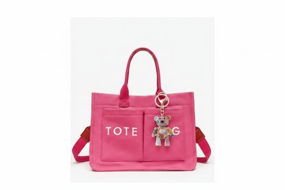 Crystal teddy bear keychain naturally hanging from pink tote bag handle