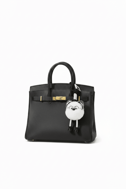Fluffy Zebra Pom Pom Keychain on Black Birkin Bag - White Background