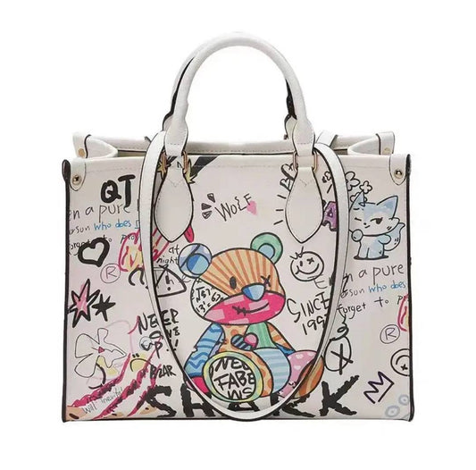 Handbag with colorful bear design and doodles on a white background