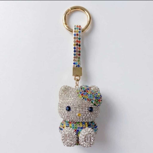 A rhinestone poodle charm in white, purple or gold
