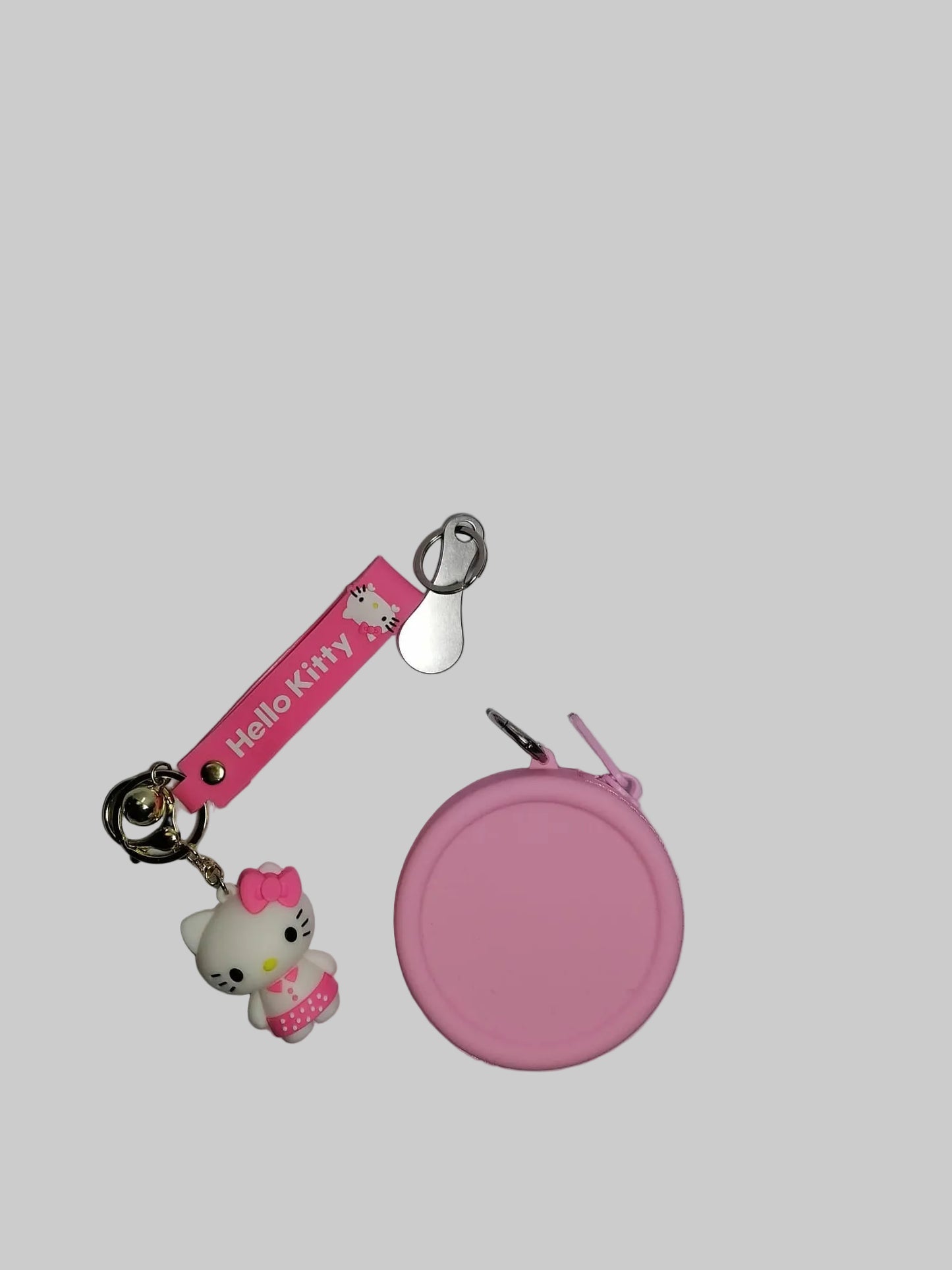 Pink keychain with Hello Kitty design and a matching pouch on a gray surface