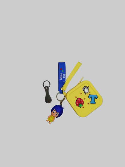 Collection of keychains and a small pouch on a white surface