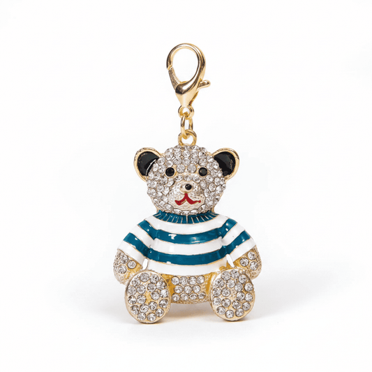 A rhinestone teddy bear charm in a striped or plaid enamel outfit
