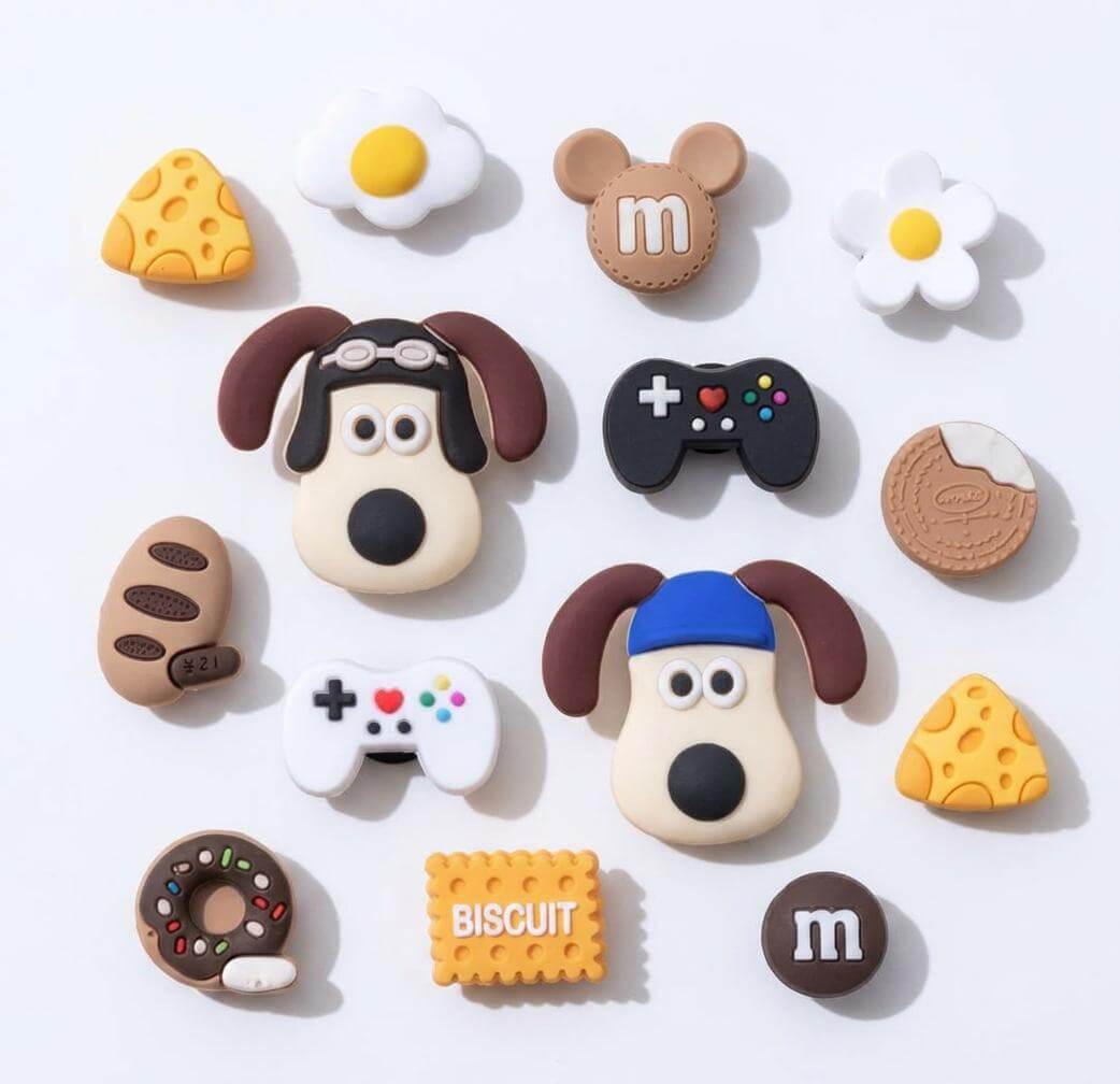 Collection of cute, cartoon-style character buttons on a white background