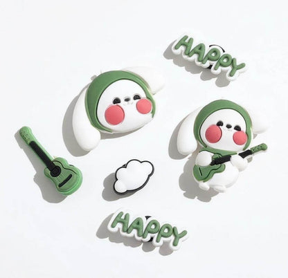 Two cartoon characters with green hats and pink cheeks, playing guitars, on a white background with 'Happy' text.