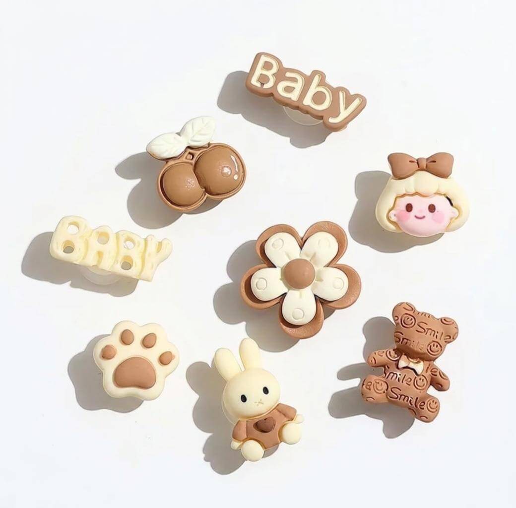 Set of baby-themed decorative items including a flower, bear, rabbit, and text on a white background.