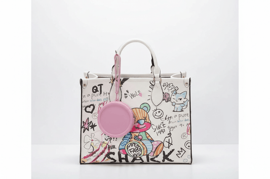 Pink coin purse dangling from graffiti tote bag