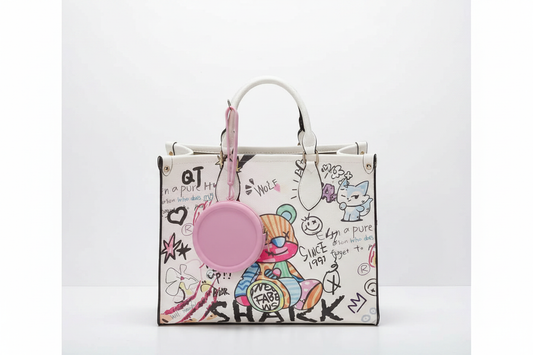 Pink coin purse dangling from graffiti tote bag