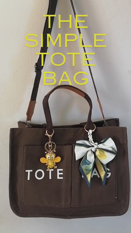 Ekene canvas tote bag in brown, shown with a 13-inch laptop, iPad and A4 folder going in