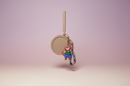 Keychain with a bear figure and round tag on a pink background
