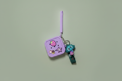 Purple pouch with cartoon character and keychain on a light green background