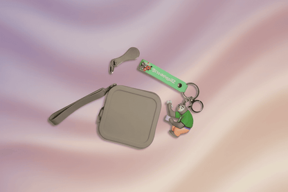 Small beige pouch with a keychain and strap on a gradient background