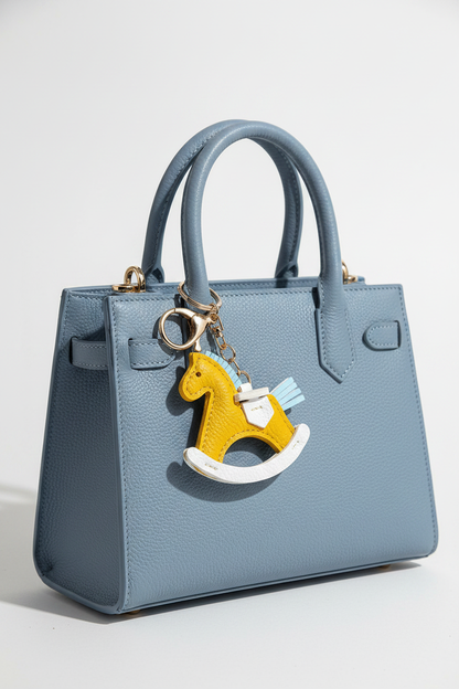 Yellow Rocking Horse Keychain on Powder Blue Bag
