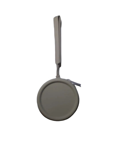 Round beige object with a string on a white background