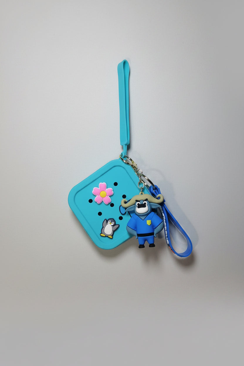 Blue pouch with cartoon character keychain on a textured white surface